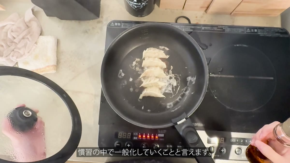 フライパンで餃子を焼く場面